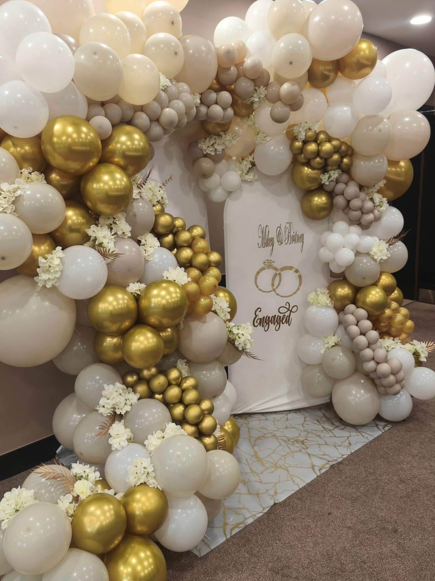 Elegant balloon garland arch installation by CK Celebrations